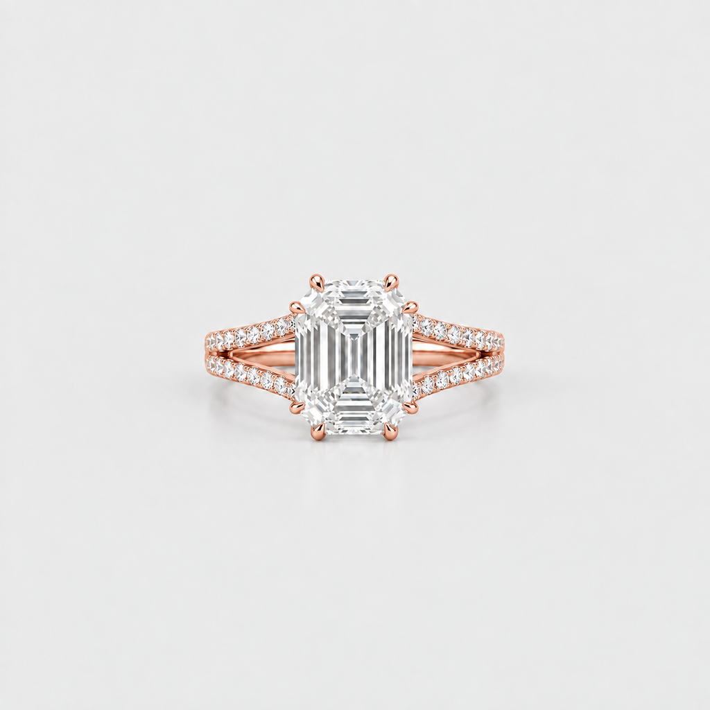 A rose gold engagement ring featuring a large emerald-cut diamond center stone and pavé-set diamonds along a split shank, shown on a clean light gray background.