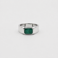 A silver-toned ring with a faceted octagonal band and a rectangular green emerald-cut gemstone, centered on a light gray background.