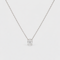 A delicate silver chain necklace with a small, clear round-cut gemstone pendant set in a prong setting, shown against a light gray background.