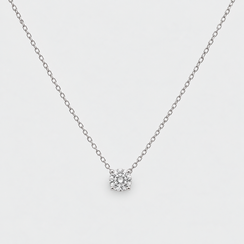 A delicate silver chain necklace with a single round-cut clear gemstone pendant, displayed against a clean white background.