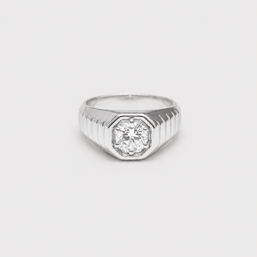 A silver-toned men's ring featuring an octagonal bezel-set round diamond on a ribbed shank, shown against a plain light gray background.