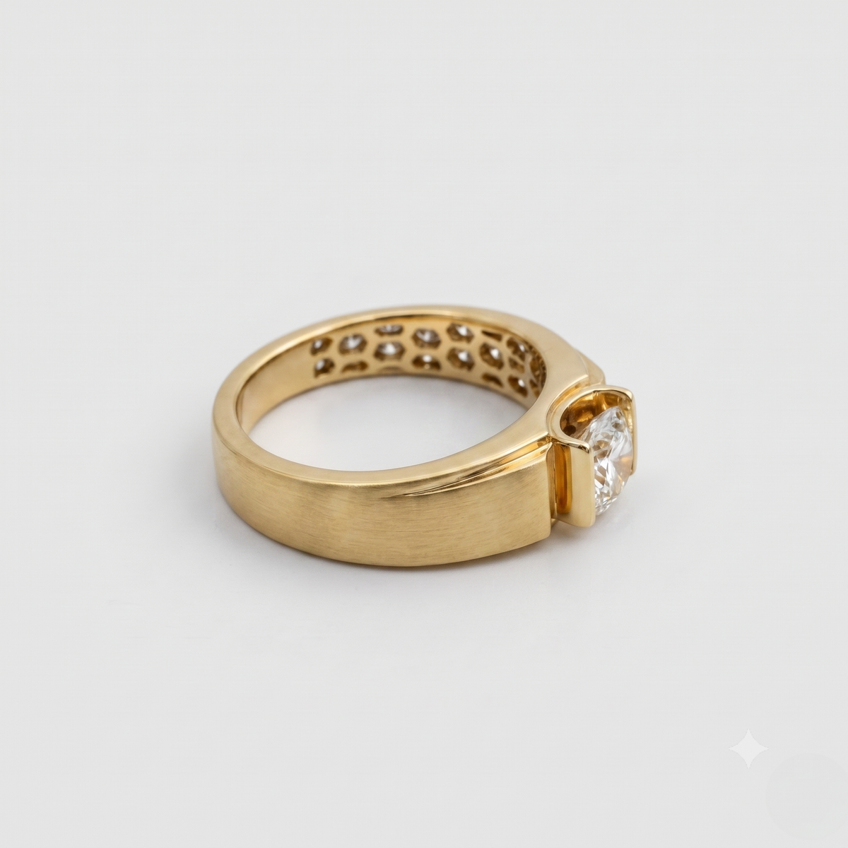 Gold ring with a diamond on a light gray background