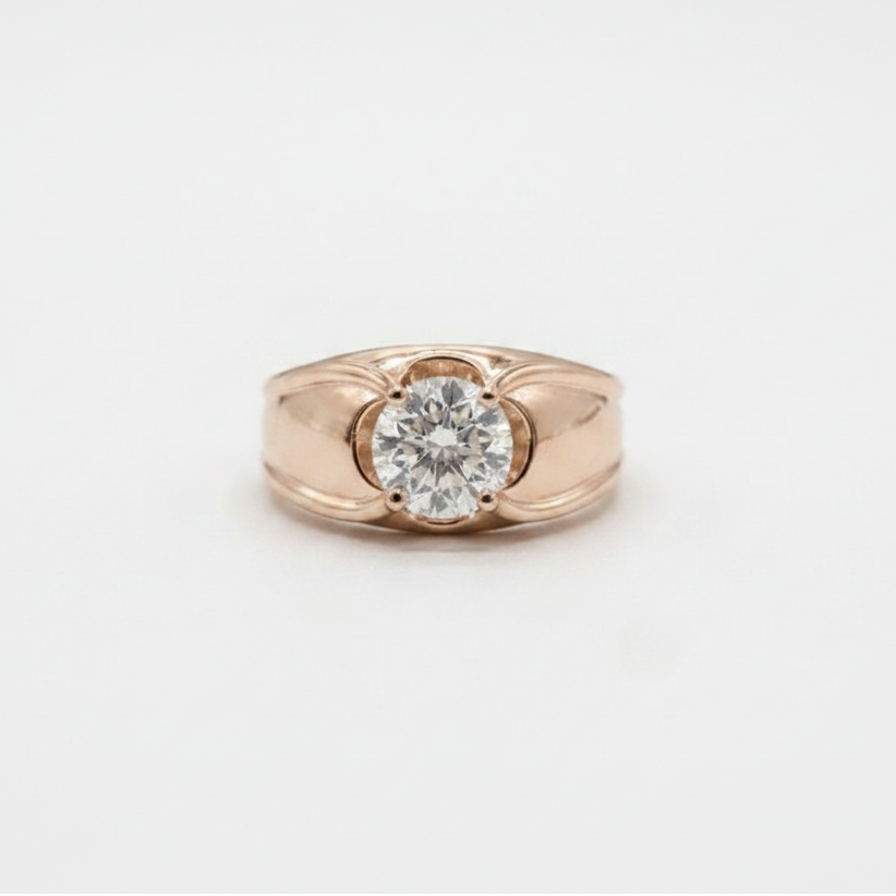 A rose gold ring featuring a round-cut clear gemstone in a four-prong setting, photographed on a clean white background.
