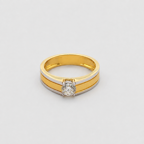 A two-tone yellow gold and white gold ring featuring a round-cut clear gemstone in a prong setting, shown on a light gray background.