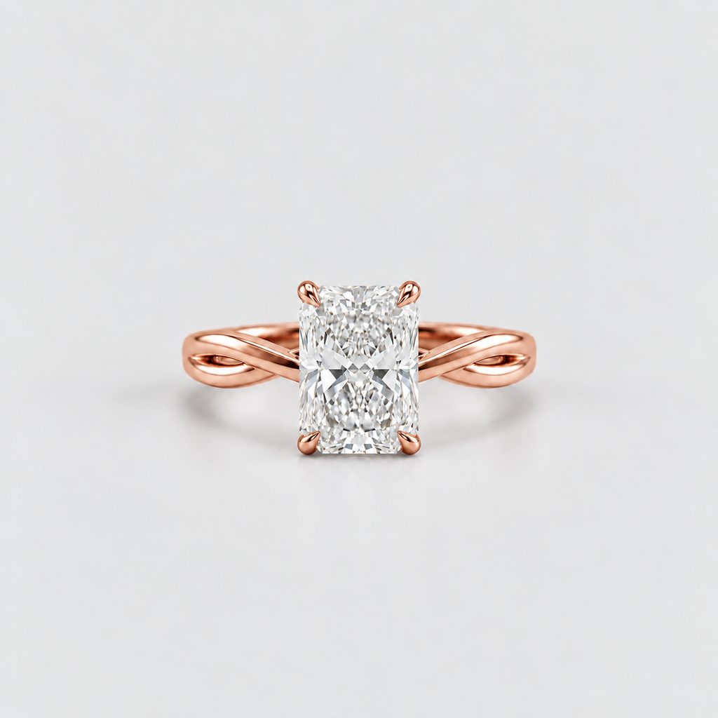 A rose gold engagement ring featuring a large rectangular radiant-cut diamond center stone, set on a split-shank band, photographed on a clean light gray background.