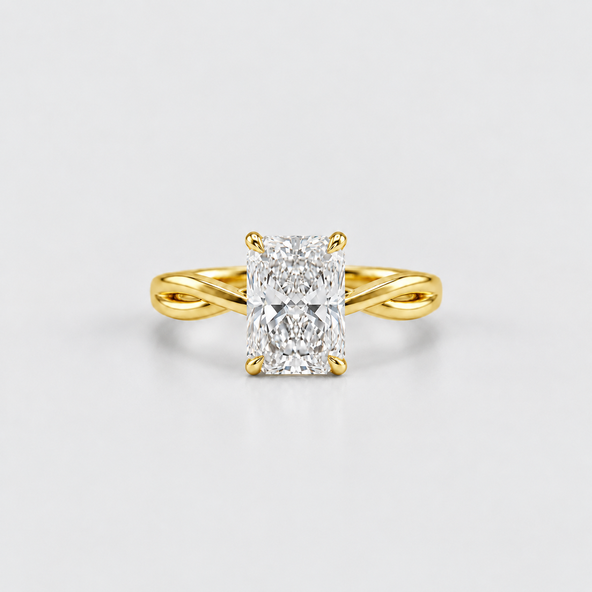 A yellow gold ring with a brilliant cut diamond center stone, set on a clean light gray background.