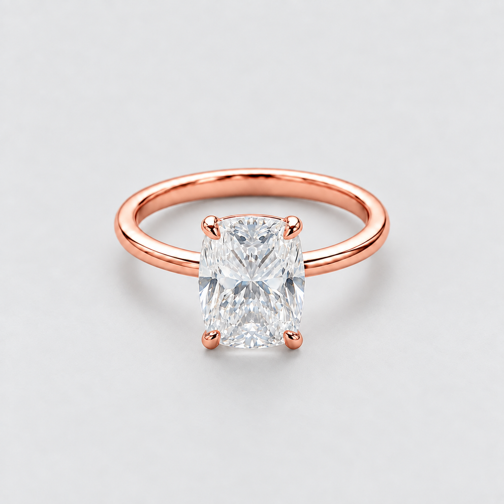 A rose gold engagement ring featuring a large rectangular radiant-cut diamond center stone in a four-prong setting, shown on a clean light gray background.