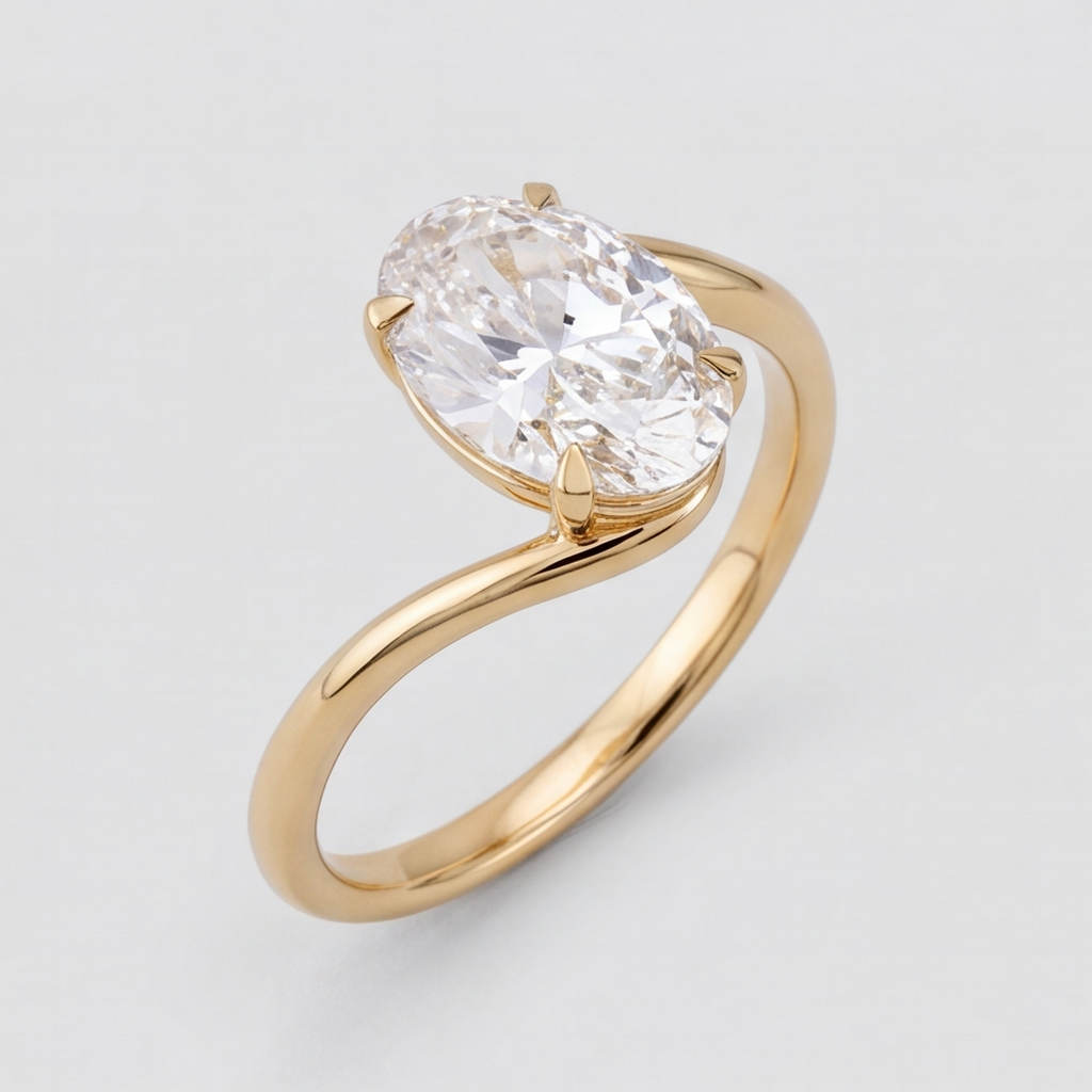 An oval-cut diamond engagement ring in a yellow gold setting, shown on a clean light gray background.