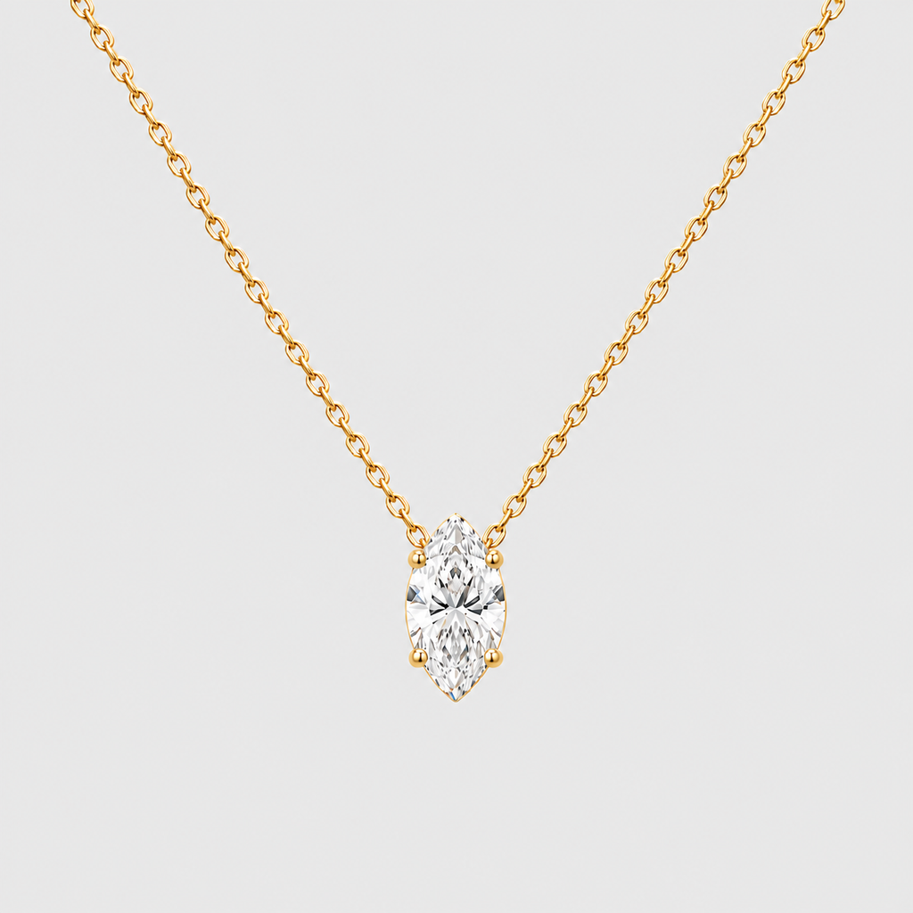 A yellow gold necklace with a marquise-cut diamond pendant, shown against a light gray background.