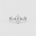 An elegant silver-tone ring featuring a marquise-cut center stone in a six-prong setting, flanked by delicate twisted band details and small accent stones, shown on a light gray background.