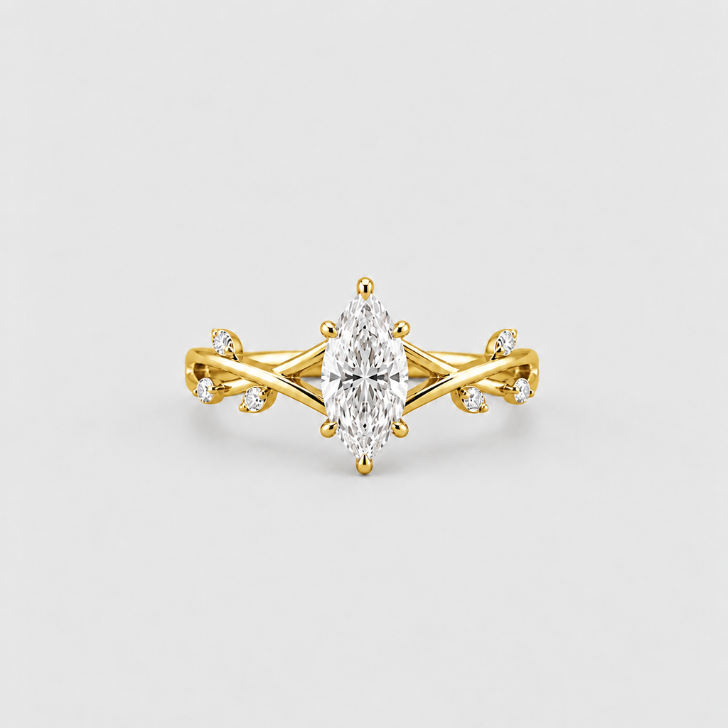 A yellow gold ring featuring a marquise-cut clear center stone and small accent stones on a twisted band, photographed on a clean light gray background.