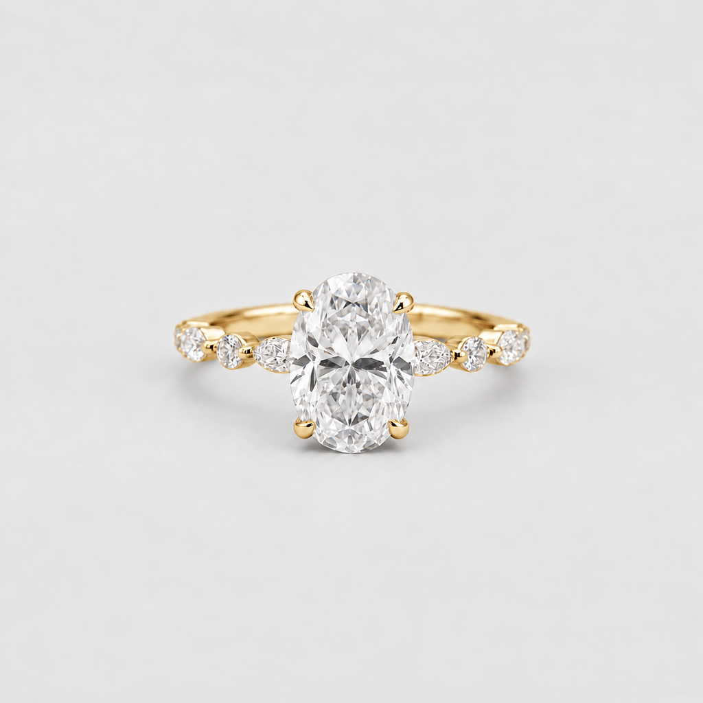 A yellow gold ring featuring a large oval-cut center diamond and smaller marquise-cut diamonds set along the shoulders, photographed on a clean light gray background.