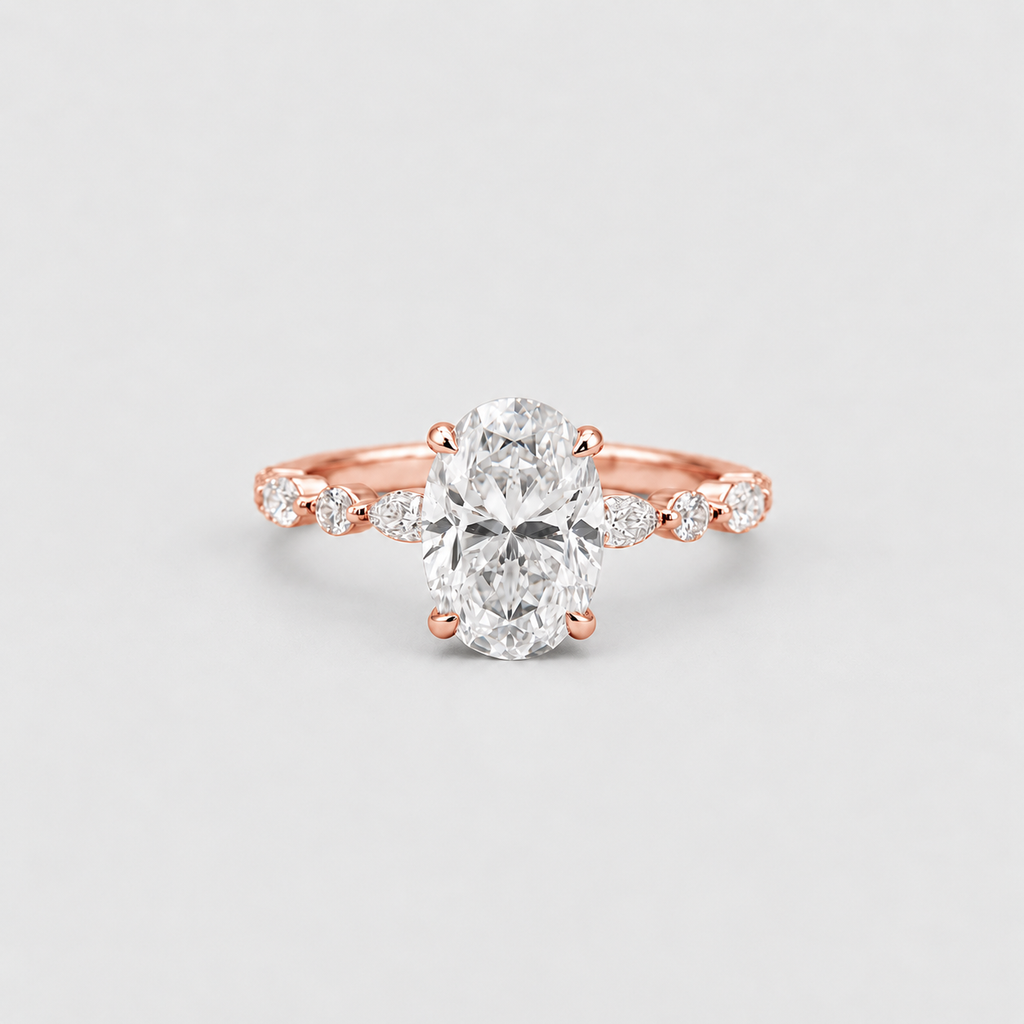 An oval-cut diamond engagement ring in a rose gold setting, featuring a diamond-accented shank, photographed on a clean light gray background.