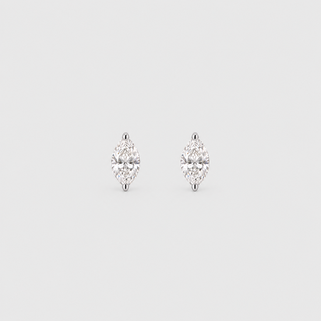 A pair of silver stud earrings with marquise-cut clear gemstones, set against a solid light gray background.