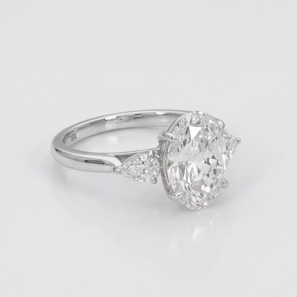A silver engagement ring featuring a large oval-cut center diamond and smaller marquise-cut diamonds on the band, set against a clean white background.