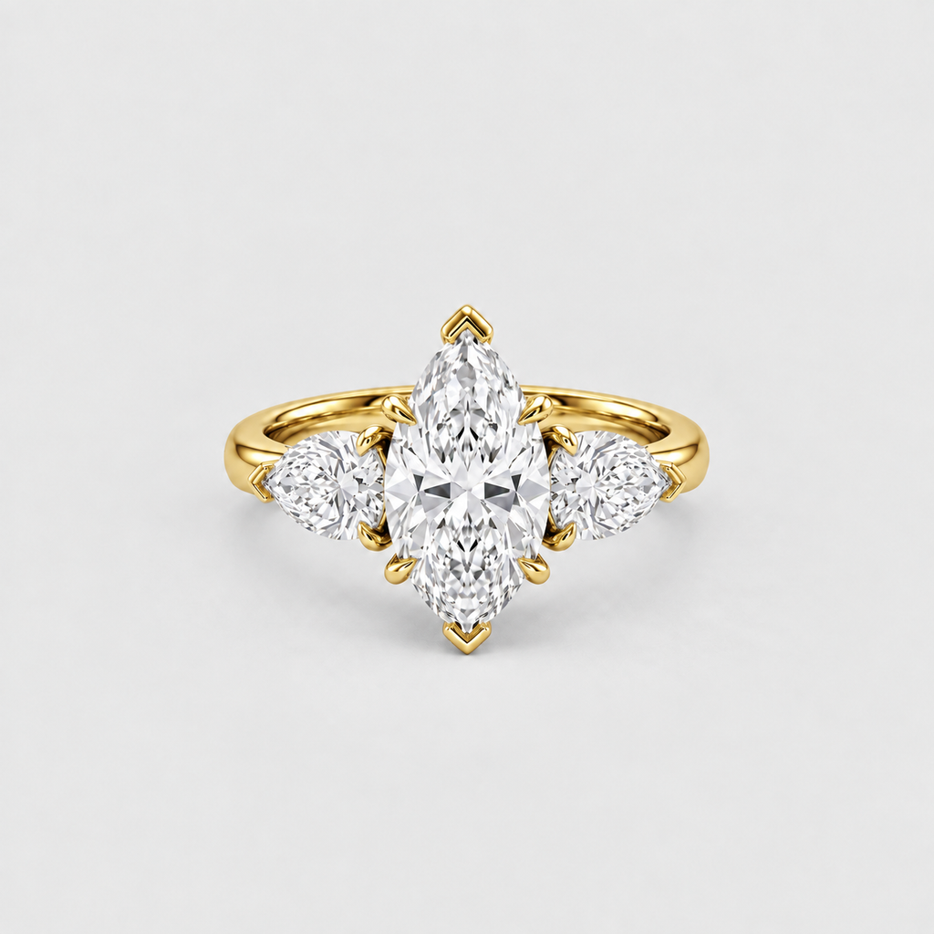 A yellow gold ring featuring a marquise-cut center diamond flanked by two round diamonds, set against a clean light gray background.