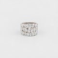 A wide silver ring featuring a dense cluster of clear gemstones in marquise and round shapes, photographed on a clean light gray background.