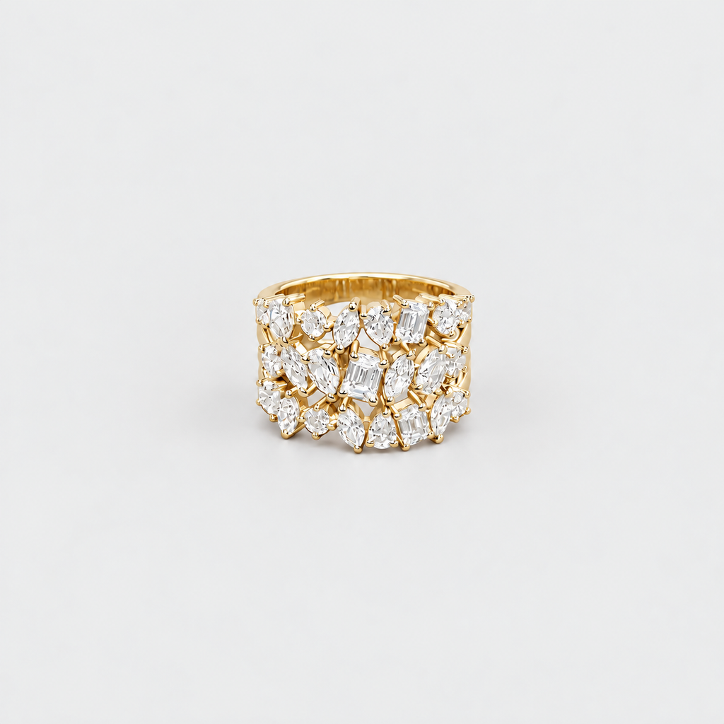 A wide gold band ring set with multiple rows of marquise-cut clear gemstones, photographed on a clean light gray background.