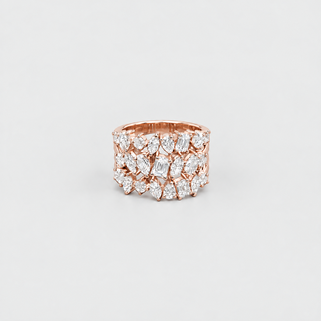 A rose gold ring featuring multiple rows of marquise-cut and oval diamonds, photographed against a clean, light gray background.