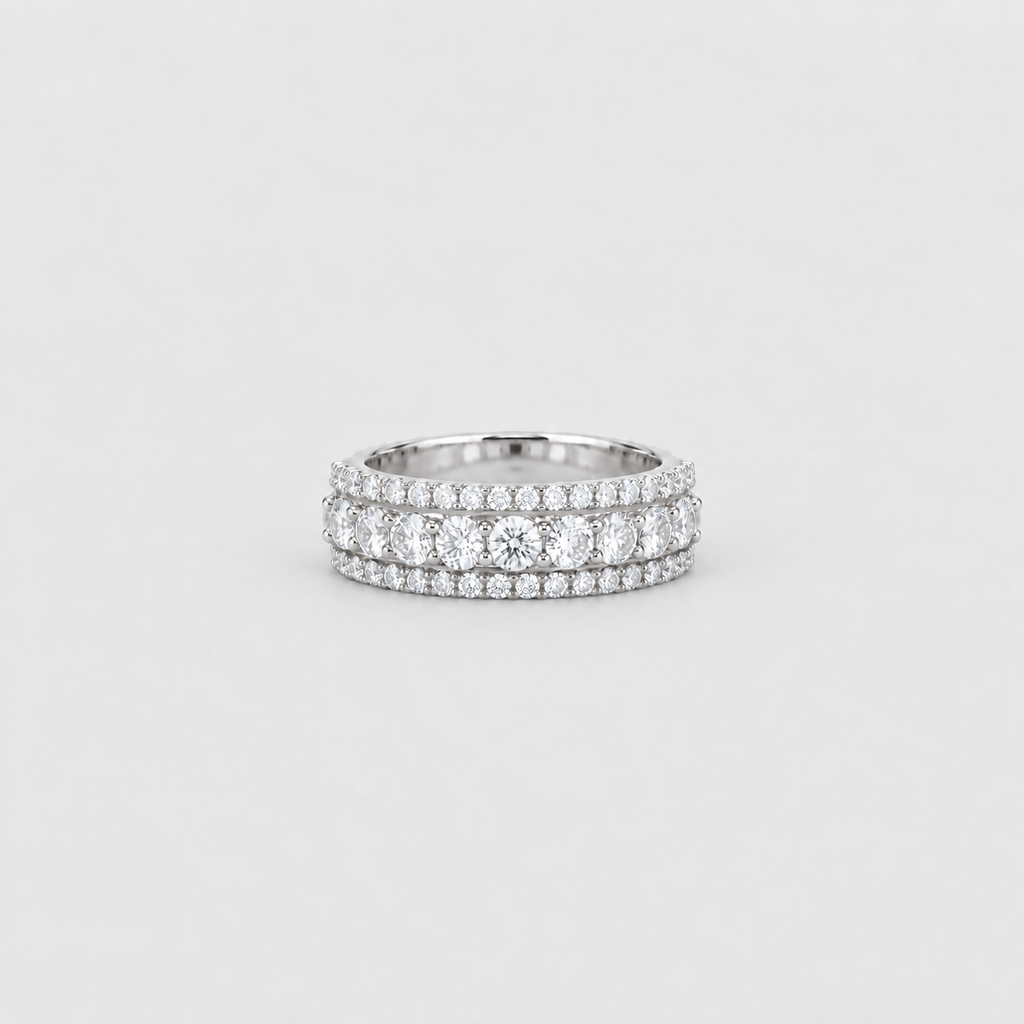 A silver double-row diamond eternity ring with a center round diamond, set against a clean light gray background.