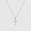 A silver cross pendant necklace with a small clear gemstone at the center, suspended from a delicate silver ball chain against a light gray background.