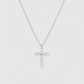 A silver cross pendant necklace adorned with clear marquise-cut and round-cut stones, suspended from a delicate silver chain against a light gray background.