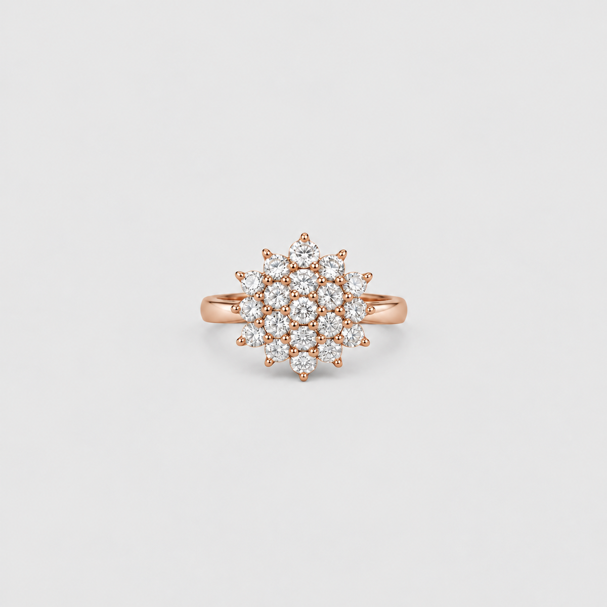 A rose gold ring with a multi-stone cluster setting featuring clear round-cut diamonds, presented on a light gray background.