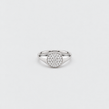 A silver-toned signet ring featuring a round pavé-set stone center, photographed on a clean, light gray background.