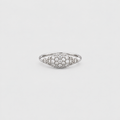 A silver pavé ring with a marquise-shaped cluster of small clear stones, photographed on a light gray background.