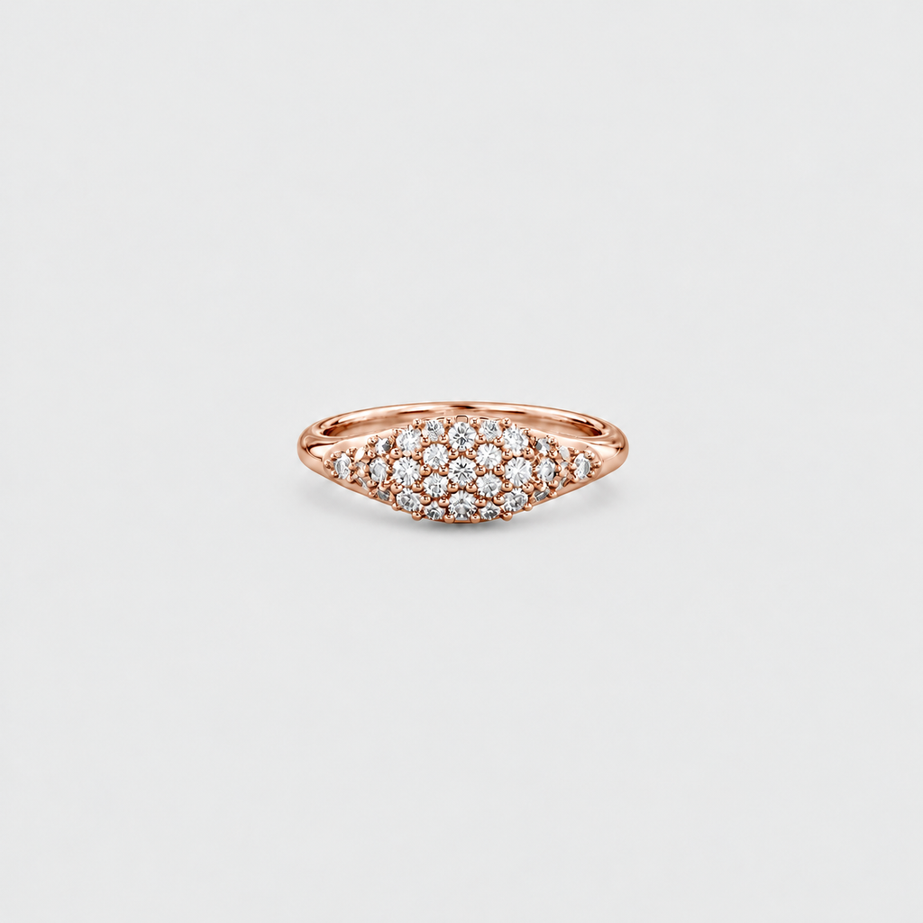 A rose gold ring with a pavé diamond cluster in a marquise-shaped setting, shown on a light gray background.