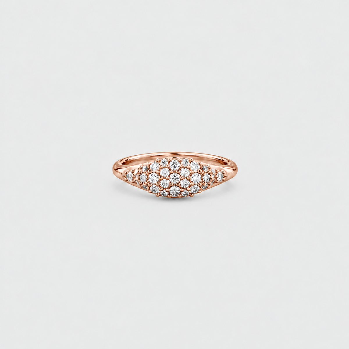 A rose gold ring with a pavé diamond cluster in a marquise-shaped setting, shown on a light gray background.