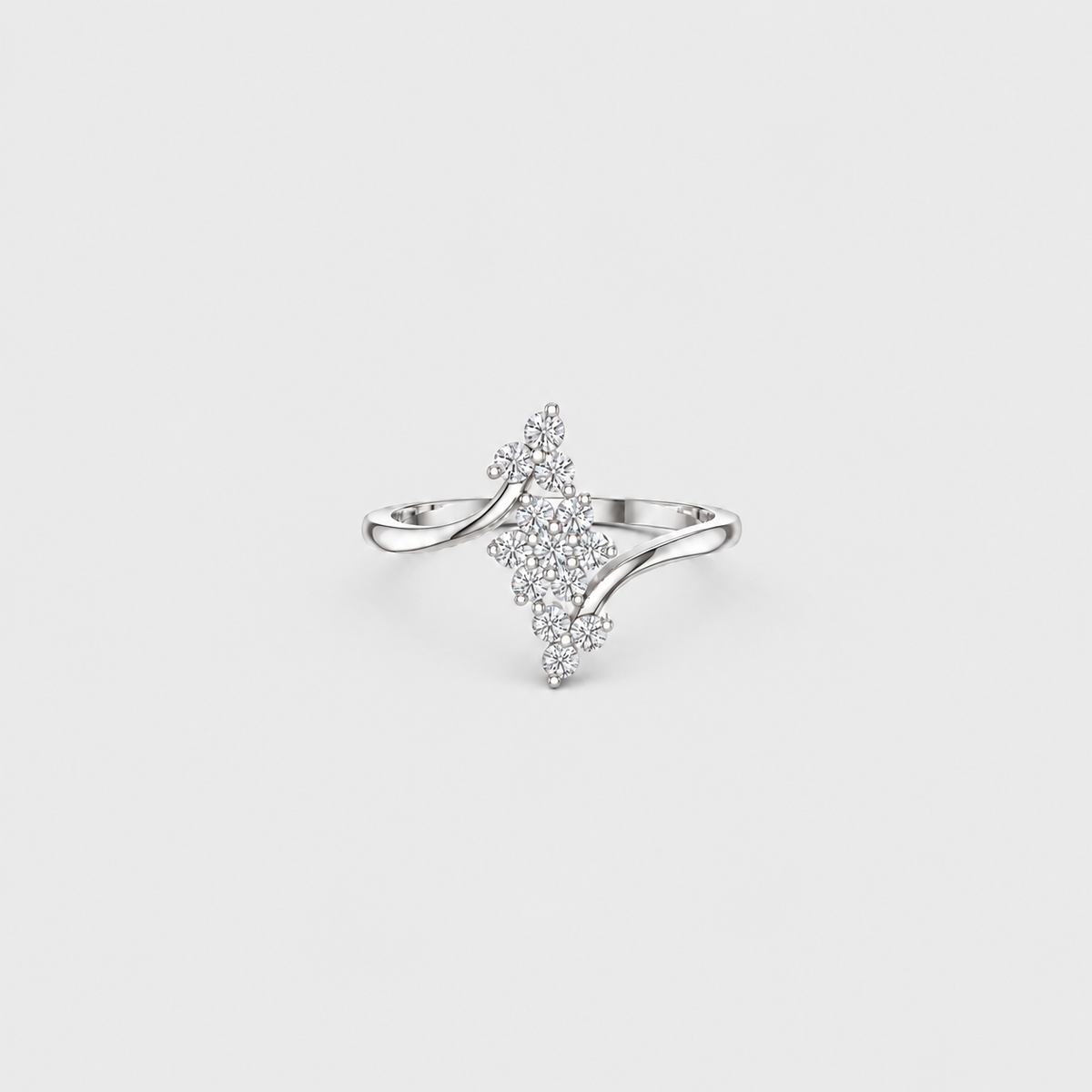 A silver ring featuring a central diamond-shaped cluster of small clear stones, with curved silver bands extending from the sides, shown on a light gray background.