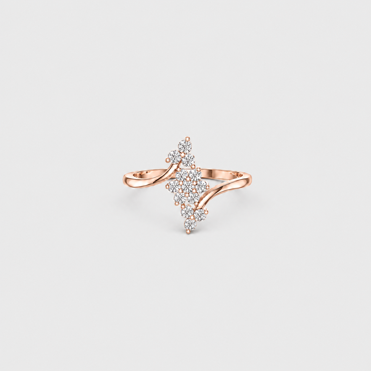 A rose gold ring with a unique, branching design set with small clear pavé stones, photographed on a light gray background.