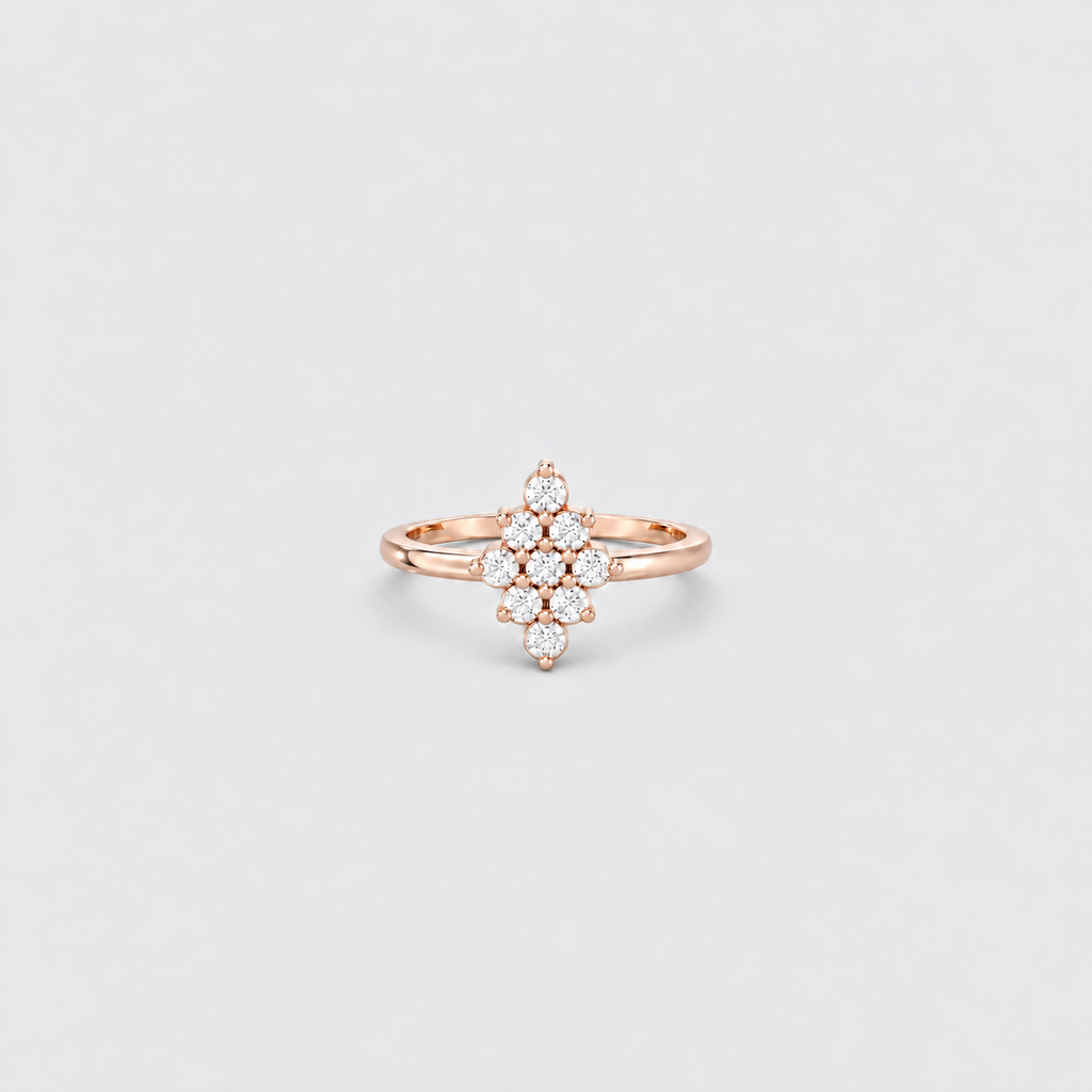 A rose gold ring with a floral cluster setting of small clear stones, centered on a light gray background.
