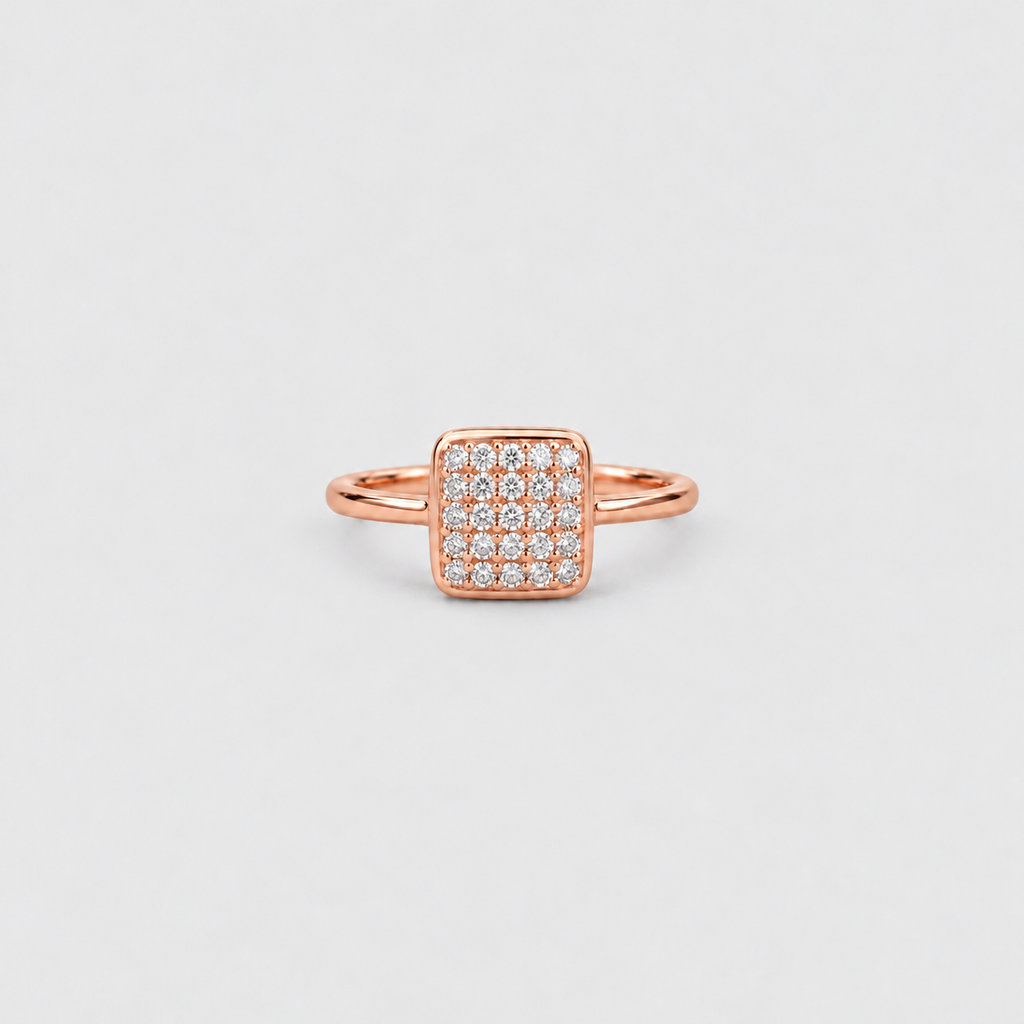 A rose gold ring with a square pavé diamond setting, photographed on a clean, light gray background.