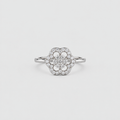 A silver-toned flower cluster ring with a central round diamond surrounded by a halo of smaller diamonds, set on a plain light gray background.