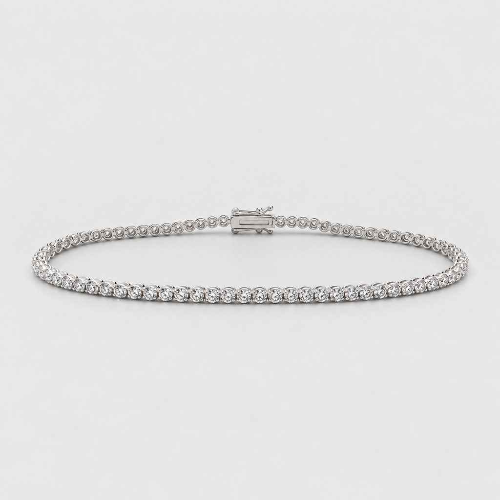 A silver tennis bracelet with a continuous row of small clear gemstones and a clasp closure, photographed on a light gray background.