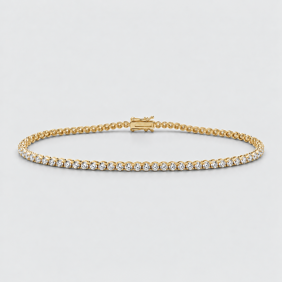 A yellow gold tennis bracelet with a row of small clear round-cut stones, displayed on a light gray background.