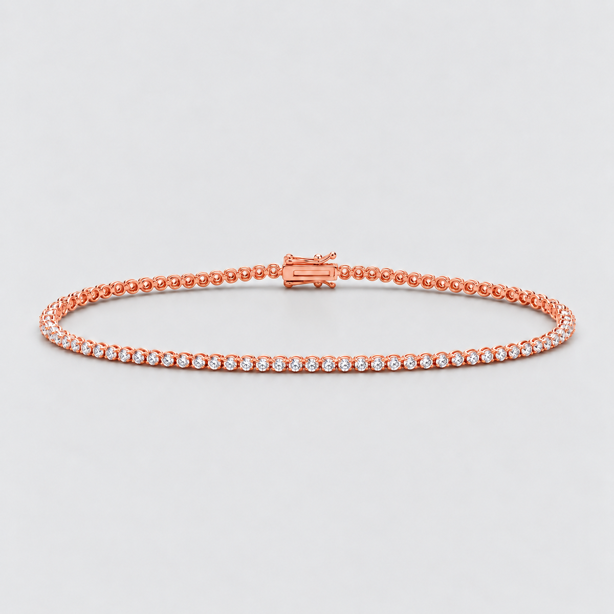 A rose gold tennis bracelet with a single row of clear round-cut gemstones, displayed on a light gray background.