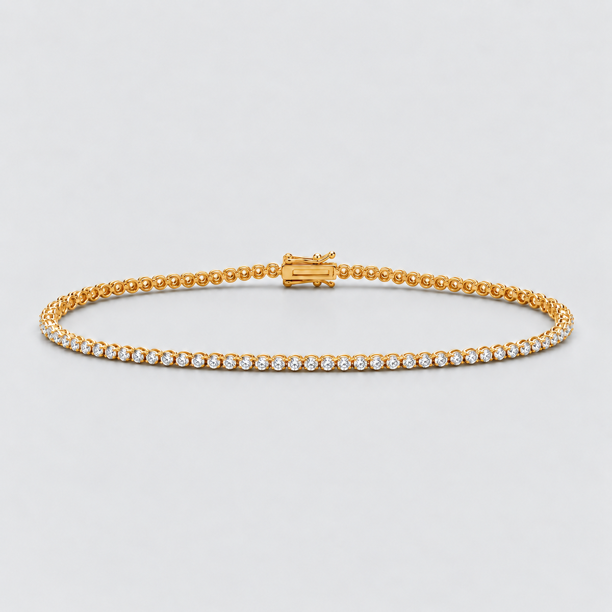 A yellow gold tennis bracelet featuring a continuous row of small clear round-cut gemstones on one side and a textured gold beaded chain on the other, displayed on a light gray background.
