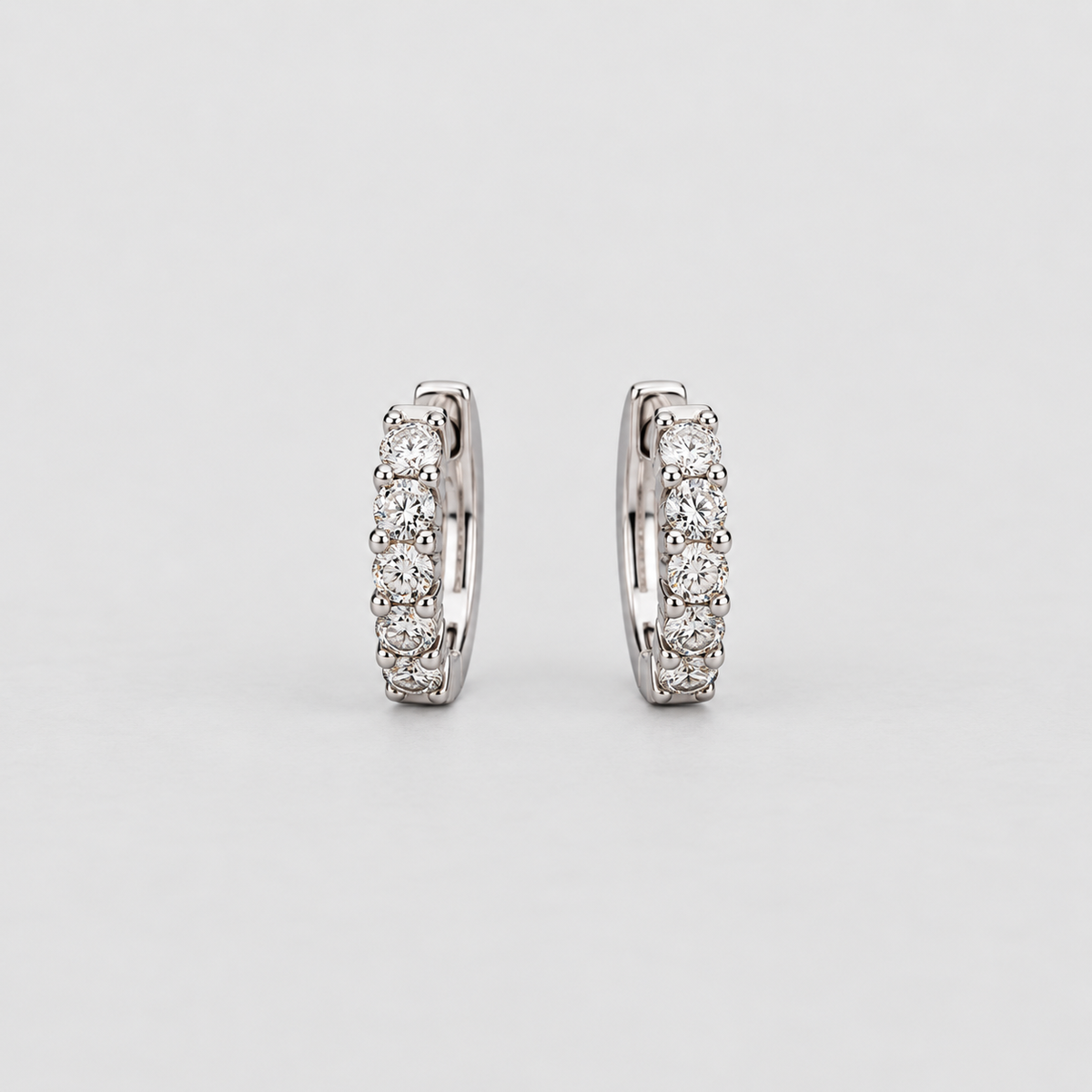 Elegant white gold huggie earrings with a graduated row of sparkling round cut lab grown diamonds