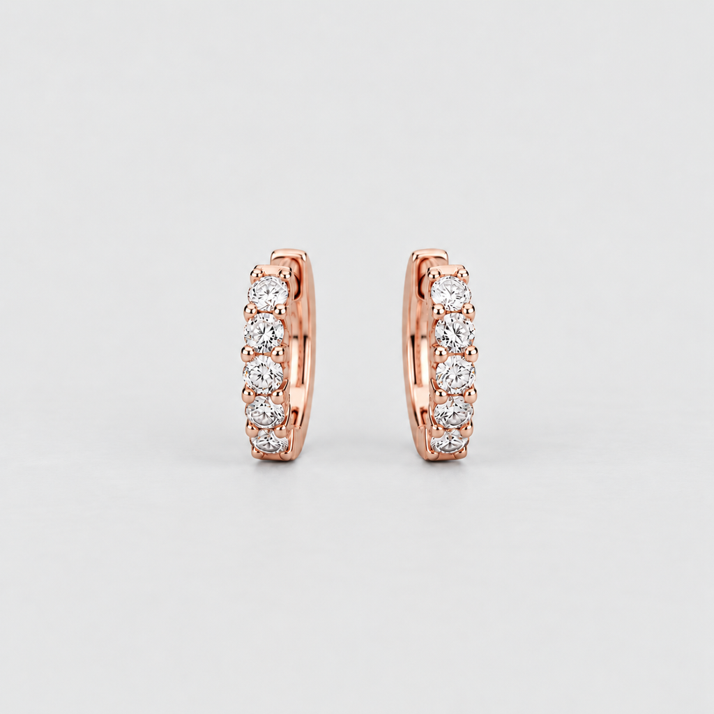Pair of rose gold huggie earrings featuring four prong-set round lab grown diamonds each