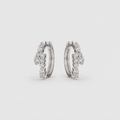 Lab grown diamond cluster huggie hoop earrings in white gold with scattered round cut diamonds, angled view