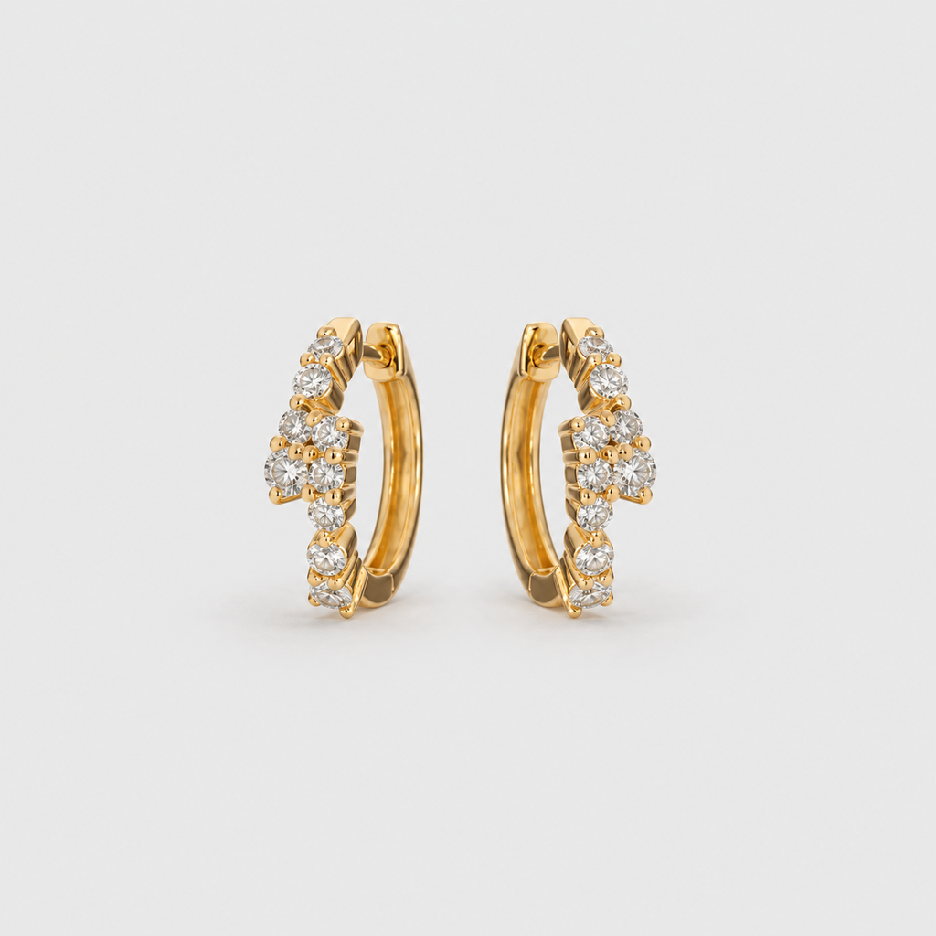 Lab grown diamond cluster huggie hoop earrings in yellow gold with scattered round cut diamonds, angled view