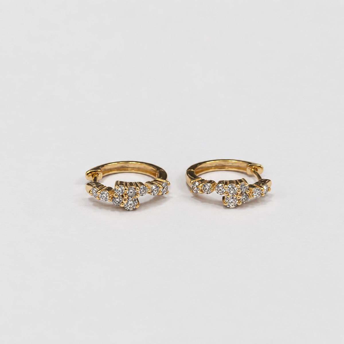 Lab grown diamond cluster huggie hoop earrings in yellow gold with round cut diamonds, top-down view