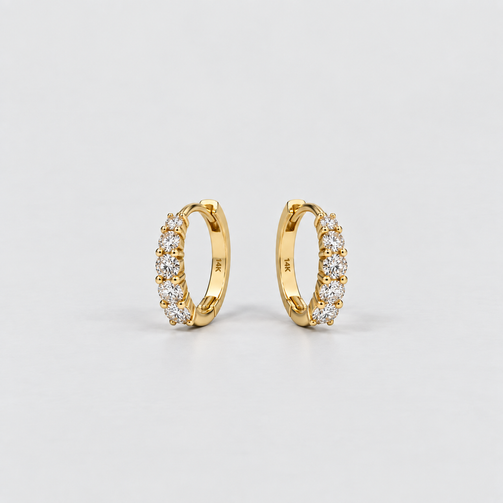 Lab grown diamond huggie earrings in 14K yellow gold, prong setting, shown as a pair on a neutral background