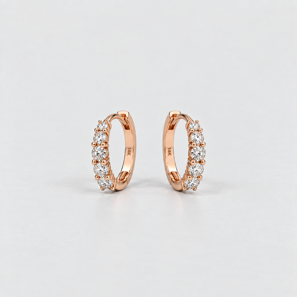 14K rose gold lab grown diamond huggie hoop earrings with five round cut diamonds each, angled view