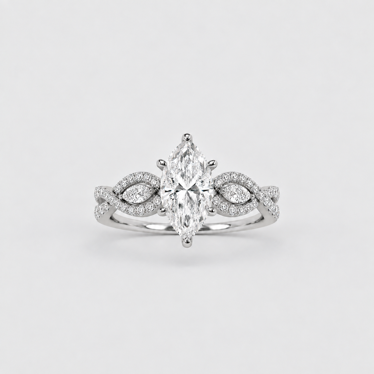 A silver-tone marquise-cut diamond engagement ring with pavé-set diamonds on the band, centered on a light gray background.