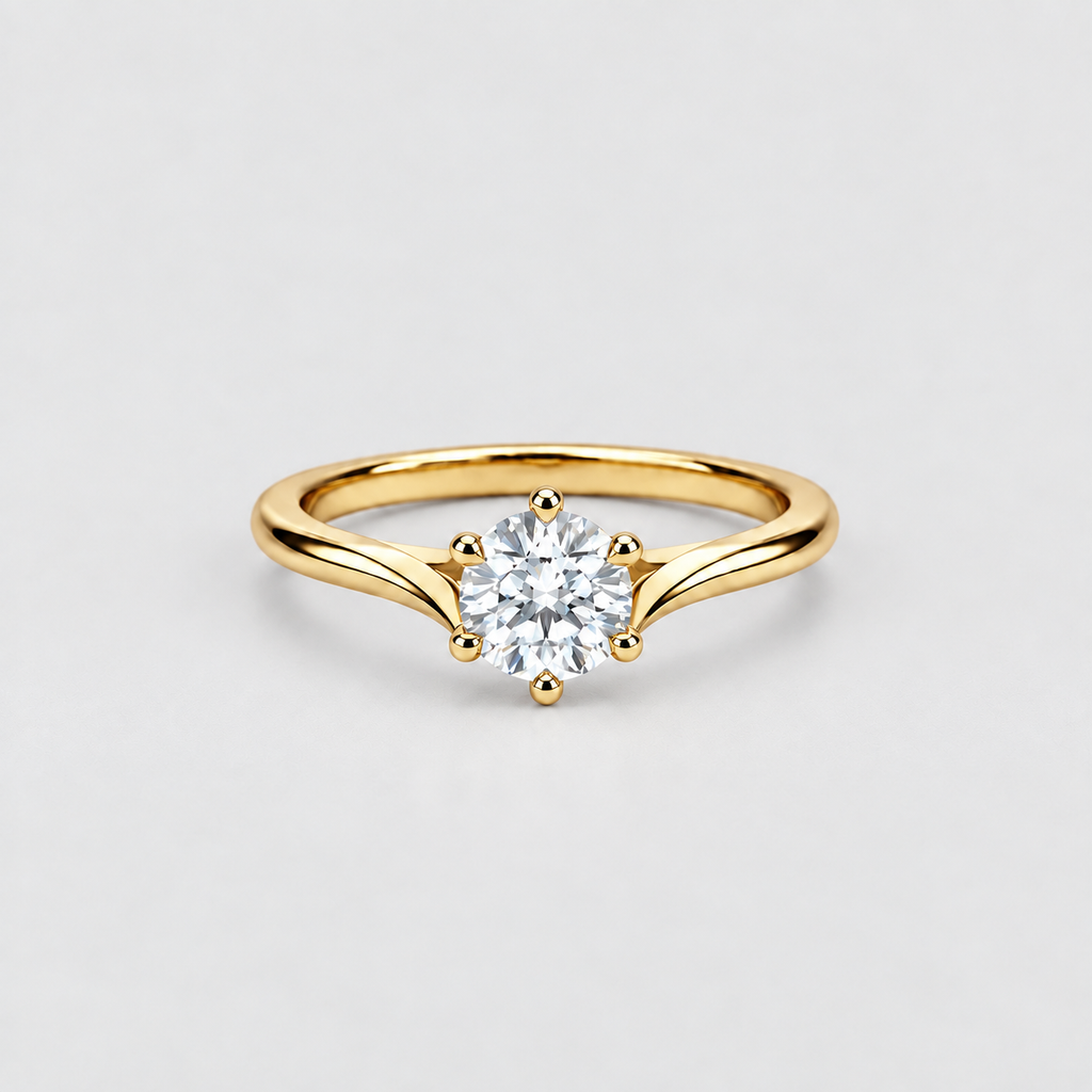 A yellow gold solitaire engagement ring with a round brilliant-cut diamond set in a six-prong setting, shown on a light gray background.
