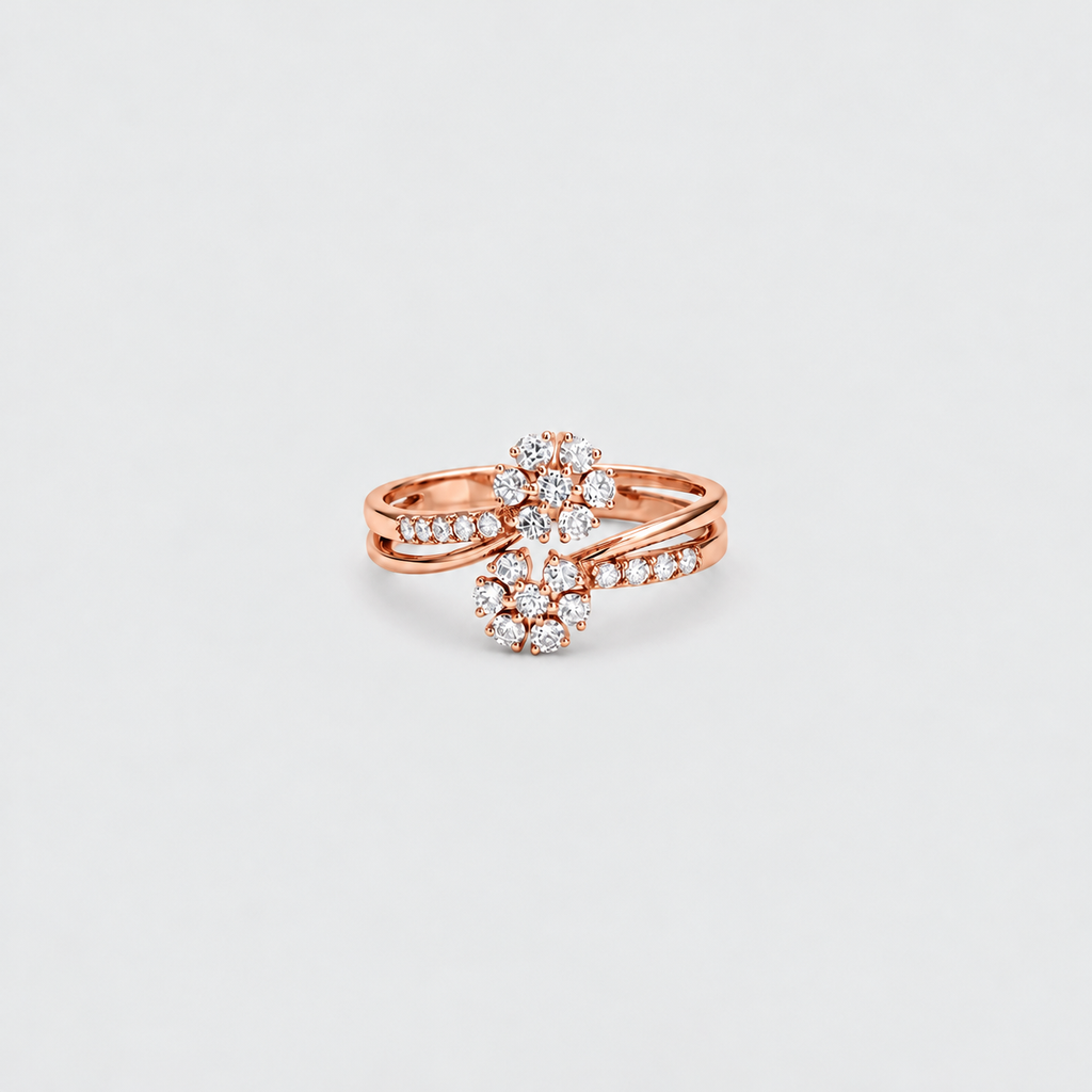 A rose gold ring with a floral cluster design set with clear gemstones, photographed on a clean, light gray background.